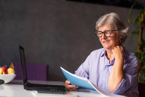 istock a grandmother with glasses is reading papers 2088864323