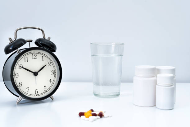 istock Pills, capsules and alarm clock on white background 2088869784
