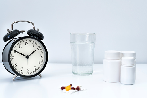 Concept photography of a vintage clock frozen in an ice cube.