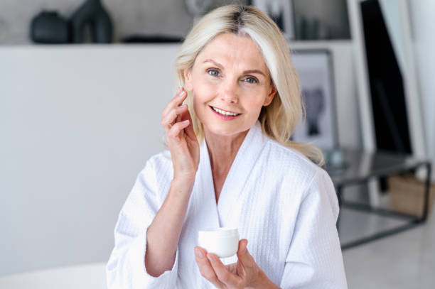 istock Woman applying cosmetic product with lifting effect on face. 2088875357