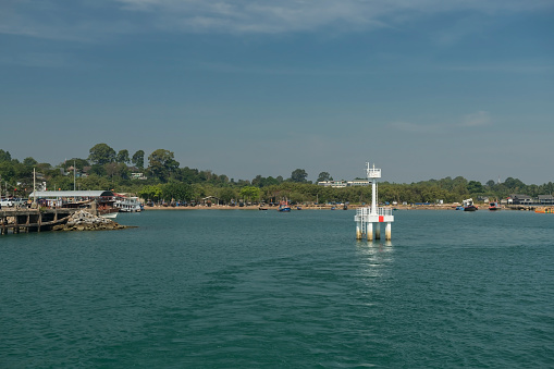 White Lighthouse at Makampom pier to transport to Ko Man Nok against blue sky, Rayong, Thailand.