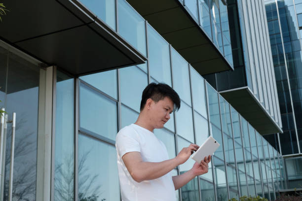 istock Male businessman holding tablet computer downstairs in office 2088883930