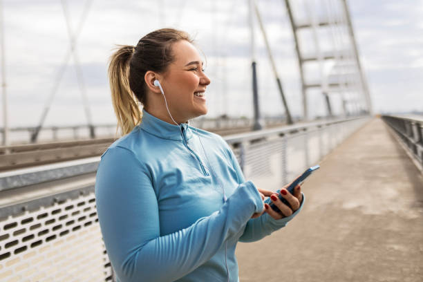 istock Overweight Woman Using Phone for Exercise 2088891000