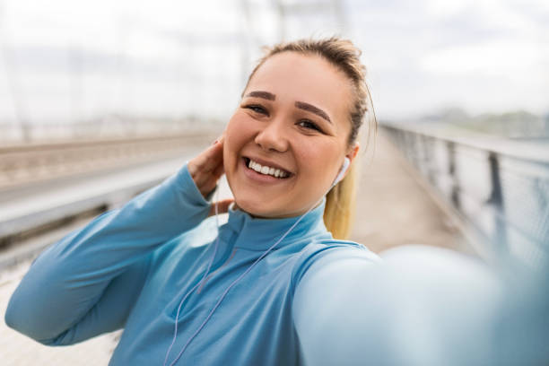 istock Overweight Woman Documenting Fitness Progress 2088893194