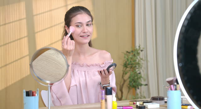 Cheerful Woman Demonstrating Makeup Application Online