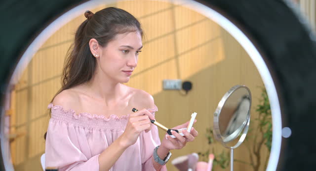 Woman Applying Blush in Makeup Tutorial Video