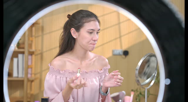 Woman Applying Lipstick in Beauty Tutorial Video