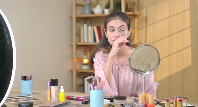Young Woman Perfecting Makeup Routine at Home
