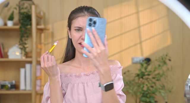 Woman Enjoying Video Call While Applying Makeup