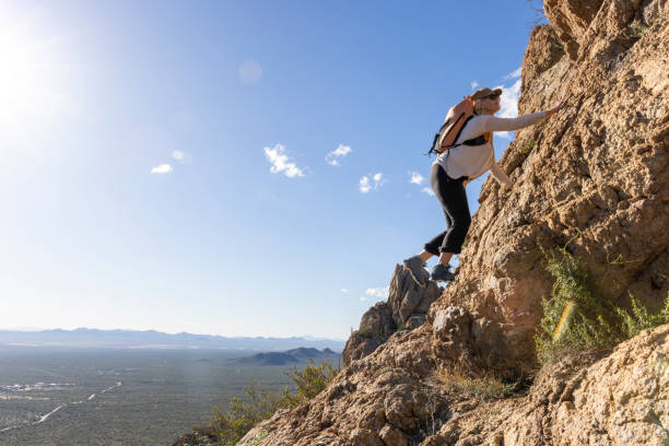 istock Mature woman ascends rock ridge crest 2088927987