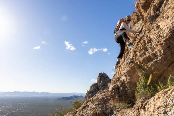istock Mature woman ascends rock ridge crest 2088929673