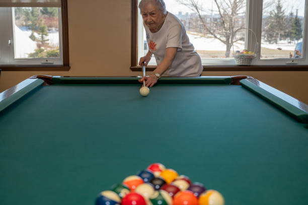 istock Senior woman playing pool 2088930741