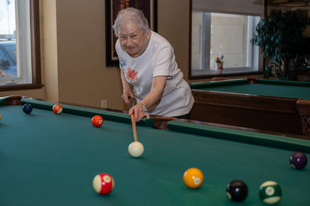 istock Senior woman playing pool 2088931253