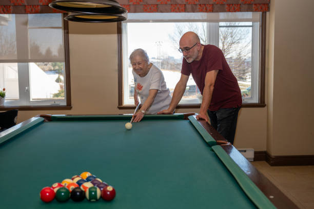 istock Senior woman playing pool with son 2088931780