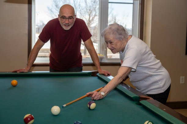 istock Senior woman playing pool with son 2088932303