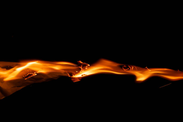 burning paper, glowing edge of paper on a black background