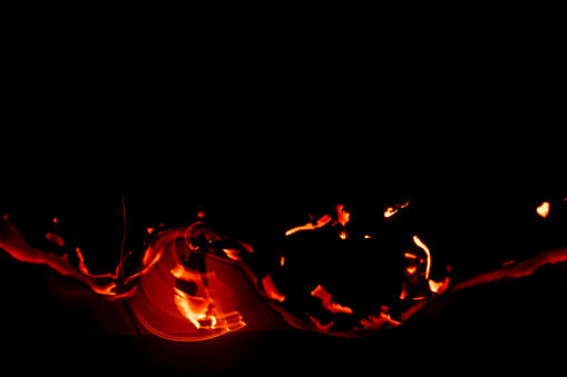 Realistic fireball with sparks over a black background
