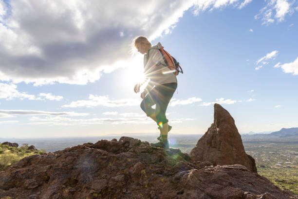 istock Hiker steps onto top of rock bluff 2088935543