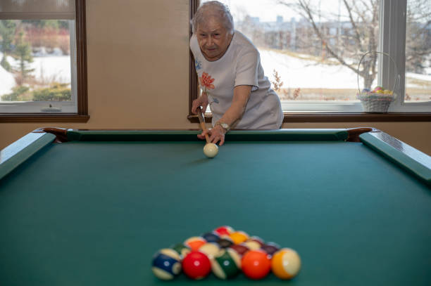 istock Senior woman playing pool 2088935547