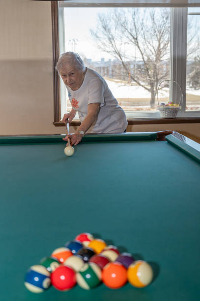 istock Senior woman playing pool 2088936050