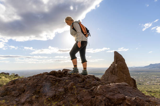 istock Hiker steps onto top of rock bluff 2088937092