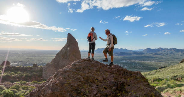 istock Hikers pause on top of boulder 2088939748