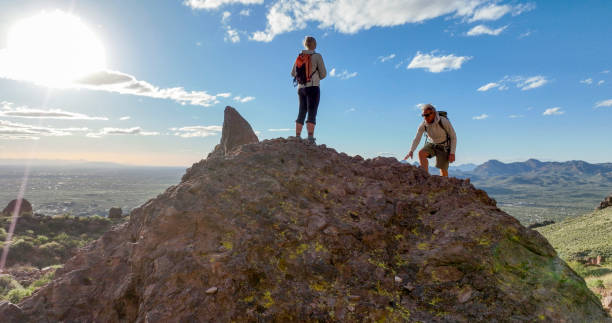 istock Hikers pause on top of boulder 2088939749