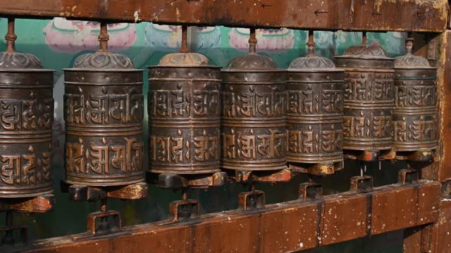 Rows of bronze prayer wheel in Buddhist temple in Kathmandu city of Nepal.