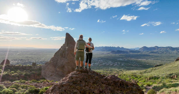 istock Hikers pause on top of boulder 2088941320