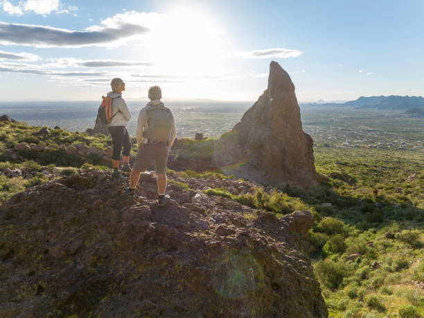 istock Hikers pause on top of boulder 2088941321