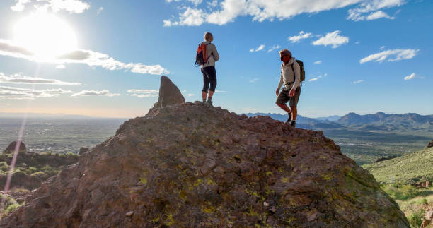 istock Hikers pause on top of boulder 2088941322