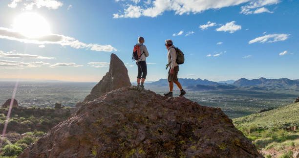 istock Hikers pause on top of boulder 2088941323