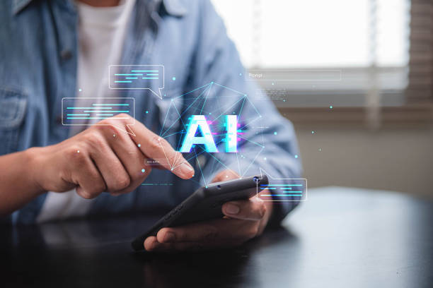 istock Concept of artificial intelligence and the potential for technology to enhance human communication and interaction. A person is using a cell phone to interact with a blue screen that says AI 2088958856