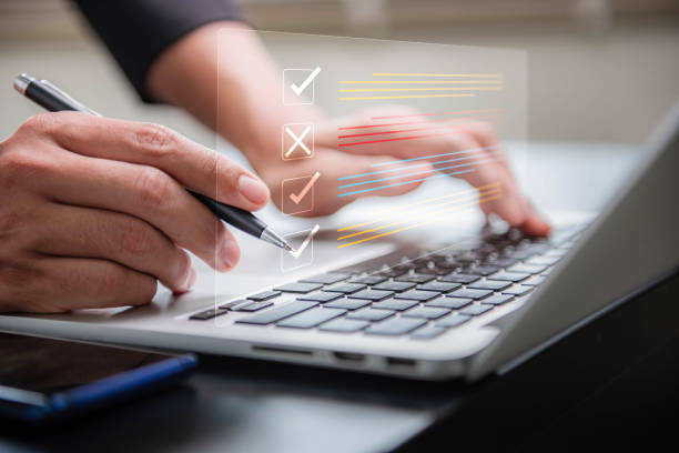 istock Task management with checklists and clipboards, completion of online survey forms To handle files effectively, corporate business technology uses process document management systems (DMS). 2088964586