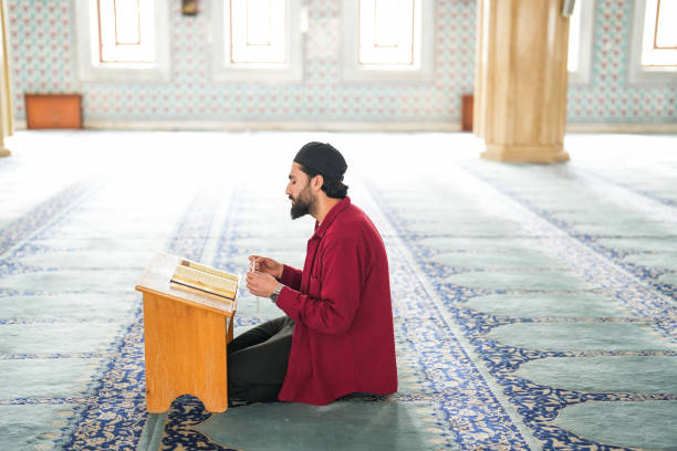 istock Muslim young man reading Quran praying in mosque 2088971458