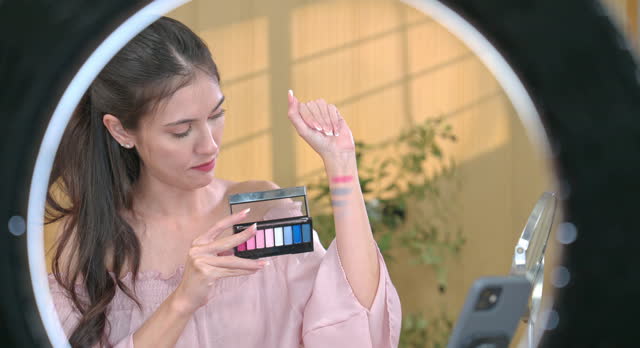 Beauty Influencer Excitedly Presenting Lipsticks and Showcasing Eyeshadow Palette Swatches