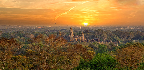 View of Angkor Wat temple from a cliff at sunrise.  It is a Hindu-Buddhist temple complex in Cambodia, considered to be the largest religious structure in the world, Siem Reap, Cambodia