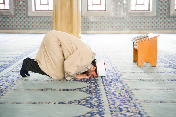istock Imam praying in the mosque prostrates 2088990872