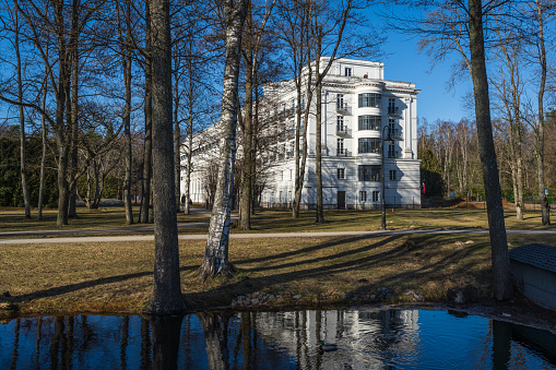 Jurmala,  Latvia - March 3, 2024: The building of the legendary resort hotel (also known as the former Kemeri sanatorium) rises above the park parterre like a white ship.