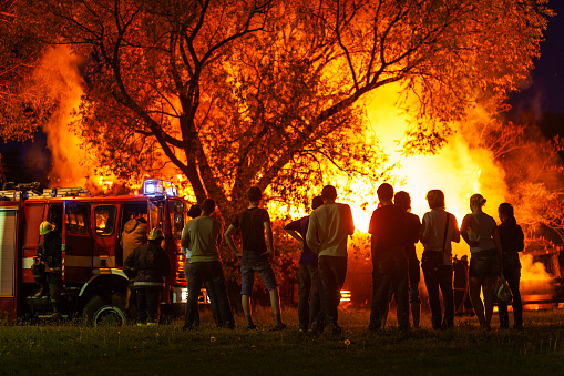 Riga, Latvia - June 20, 2006: A group of young people watch a fire being extinguished