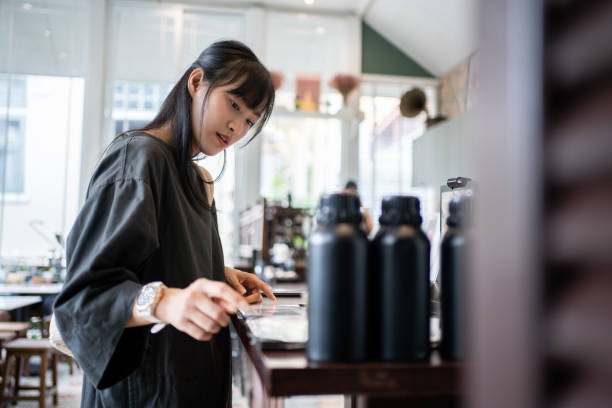 istock Asian Woman Decides Over Menu in Cozy Cafe. 2089023417