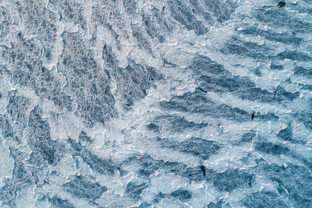 Aerial top down view of ice surface. Frozen sea surface texture