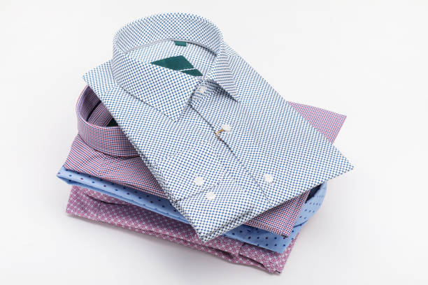 Close-Up Of Pink Shirt Folded Over White Background