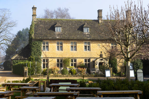 Bourton on the Water on a misty spring morning. This image captures the enchanting atmosphere as the village awakens. The mist was hovering over the River Windrush and the charming stone bridges, adding a layer of tranquillity to this picturesque Cotswolds village, renowned for its scenic beauty and peaceful waterside setting.