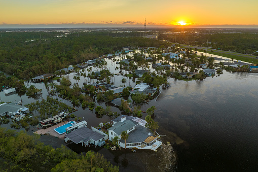 Aftermath of natural disaster. Surrounded by hurricane Ian rainfall flood waters homes in Florida residential area.