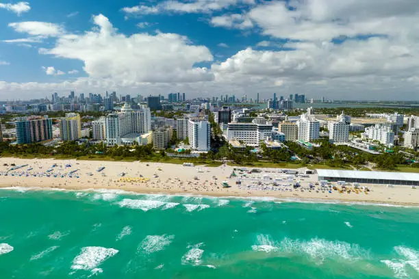 Photo of American southern seashore of Miami Beach city. Tourist infrastructure in Florida, USA. South Beach high luxurious hotels and apartment buildings