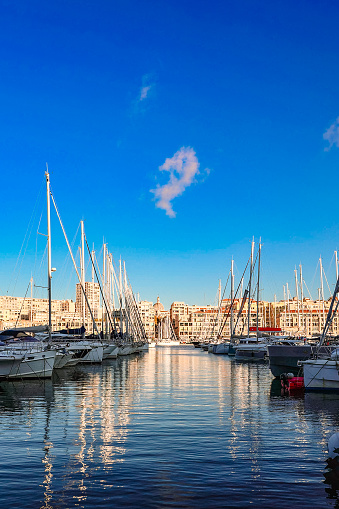 Marseille, France - December 2, 2023: Panoramic view of old port of Marseille with yachts reflected in water, Marseille, France
