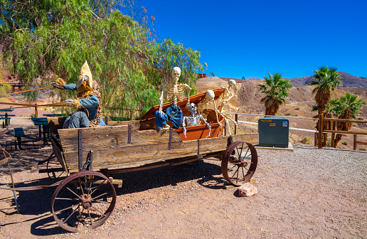 Calico Ghost Town,  California, United States - October 6, 2023: Skeleton on an old wooden cart