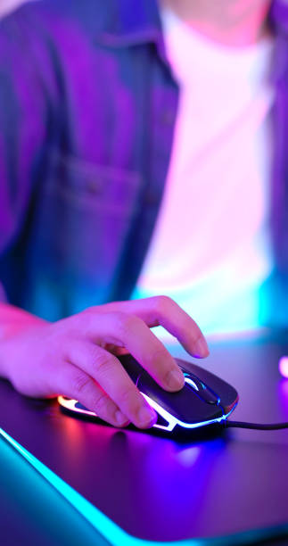 Female fingers playing computer game. Red and blue light. Esports player.