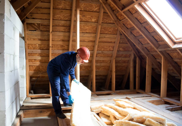 istock Roof insulation. A worker puts glass wool insulation in the attic. 2089117807